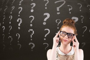 Thoughtful woman with question symbols